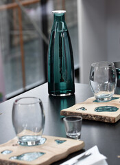 Detail of hand, glass and freshly roasted coffee.