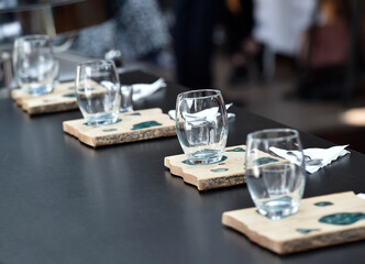 Detail of hand, glass and freshly roasted coffee.