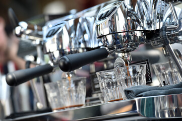 Espresso. Detail of coffee flowing from a professional espresso machine.