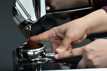 Filter holder filled with freshly ground coffee. Espresso accessory.