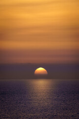 Sunset over the horizon of the sea, orange sunset colors, sea waves and a feeling of tranquility. Gran Canaria.