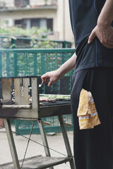 Barbecue chef. Hand holding raw meat. 