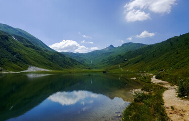 Fototapeta na wymiar trail for hiker on the shore from a gorgeous mountain lake