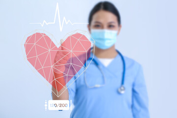 Female Asian cardiologist using virtual screen on light background