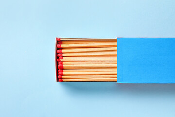 Box with matches on color background