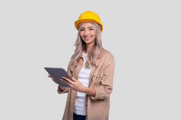 Girl Construction Worker Smilling Holding Tablet Watching Front Isolated. Girl Working with Tablet. Modern Construction, technology, Work concept