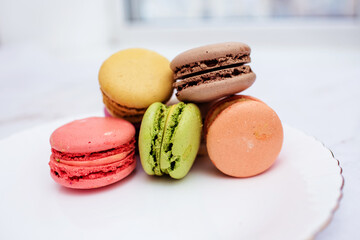 Beautiful variety of macaroons on marble background. Stylish arrangement sweet. Flat lay, top view. 
