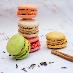 Beautiful variety of macaroons on marble background. Stylish arrangement sweet. Flat lay, top view. 