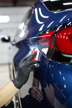 Car detailing - Hands with polisher in auto repair shop. Selective focus..