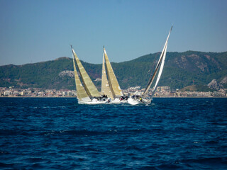 Fototapeta premium sail boat yacht in race regatta with mountain background