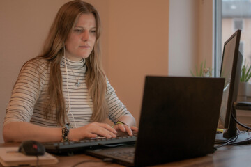 Businesswoman working on laptop computer sitting at home and managing her business via home office during Coronavirus or Covid-19 quarantine	
