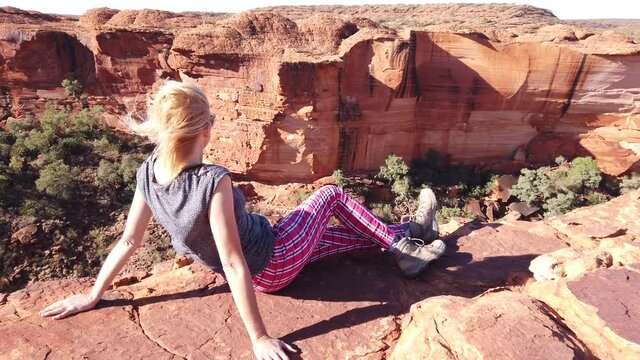 Watarrka national park, Northern Territory NT, Australia. Caucasian tourist woman looking panoramic views of Kings Canyon in Red Center Outback.