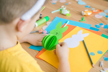 Little kid boy holding Bunny  for Easter greetings card. Children's art project. DIY concept