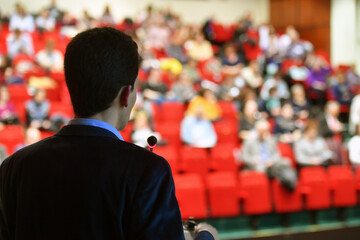 Speakers. The person speaking in front of a room, presentation.