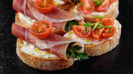 bruschetta with Italian prosciutto and tomatoes close up