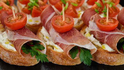 bruschetta with italian prosciutto or spanish jamon top view. stylish snack