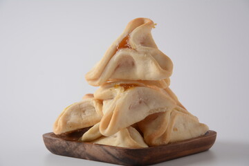 Tasty Hamantaschen, triangular filled-pocket cookies or 'Haman's ears' for Purim holiday celebration concept (Jewish carnival holiday)