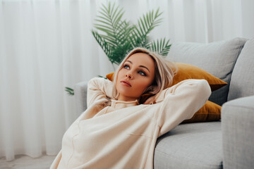 Relaxed Beautiful caucasian young woman enjoying rest on comfortable sofa, calm attractive girl relaxing on couch, meditating at home, peace of mind, headshot portrait, copy space