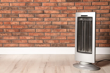 New modern electric heater on floor in room, space for text
