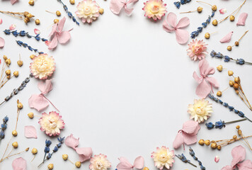 Frame of beautiful dried flowers on light background, flat lay. Space for text