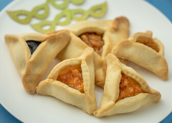 Close up of Hamantaschen cookies or hamans ears and masks  for Purim celebration (Jewish carnival holiday).  Selective focus.