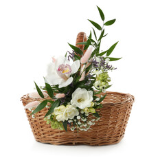 Wicker basket decorated with beautiful flowers on white background. Easter item