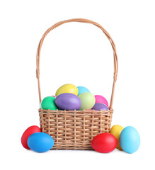 Wicker basket with bright painted Easter eggs on white background