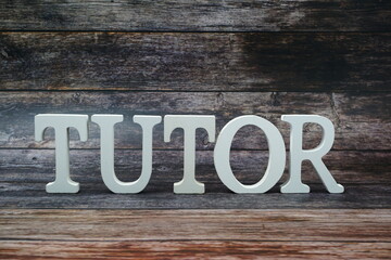 Tutor Word alphabet letters on wooden background