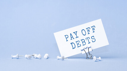 Pay off debts - concept of text on business card