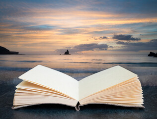 Digital composite image of Beautiful sunrise landsdcape of idyllic Broadhaven Bay beach on Pembrokeshire Coast in Wales in pages of open book