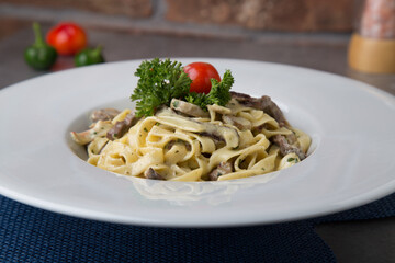 Pasta with beef, greens and tomatoes