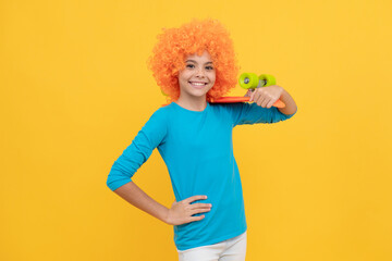 happy teen girl in fancy clown wig hold penny board, childhood