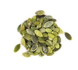 Pumpkin seeds isolated on white background. Green pepita seeds. Top view.
