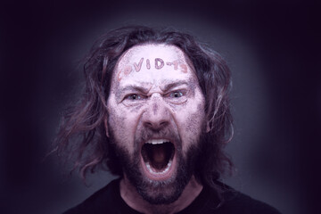 Covid-19 / Coronavirus. Human Portrait of a disease. Man screaming with a red text wrote in the forehead.