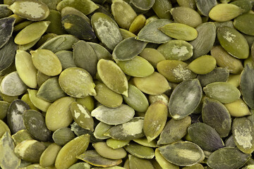 Pumpkin seeds background. Green pepita seeds. Top view.