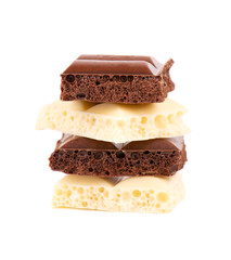 Porous chocolate pieces isolated on white background. Black and white aerated chocolate.