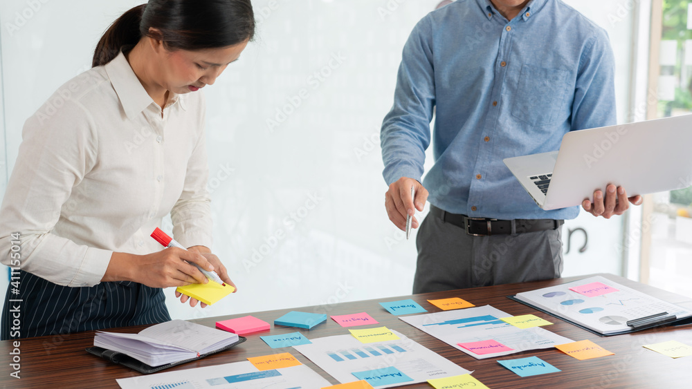 Poster businessman stick colorful notes to brainstorming on the table working on new project to share idea 
