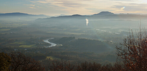 early morning mist on the Canal of Provence landscape with blue mountains
