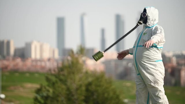 A person with a EPI virus suit and a gas mask on their face
