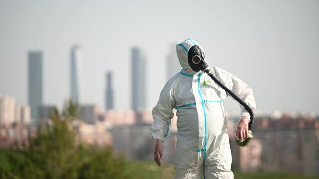 A person with a EPI virus suit and a gas mask on their face