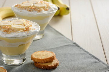 Cream dessert and cookies on wooden table