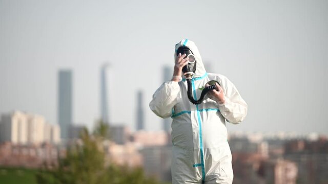 A person with a EPI virus suit and a gas mask on their face