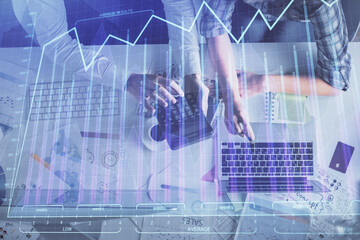 Double exposure of man and woman working together and financial graph hologram drawing. market analysis concept. Computer background. Top View.