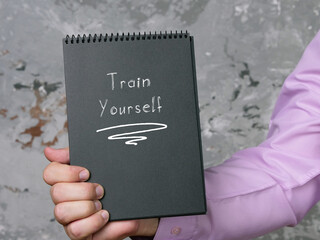 Lifestyle concept meaning Train Yourself with sign on the sheet.