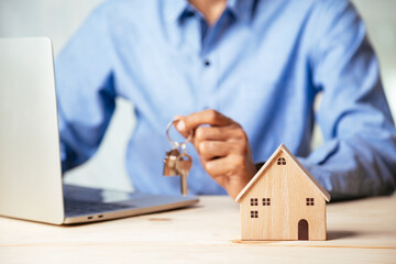House model with real estate agent and customer discussing for contract to buy house, insurance or...
