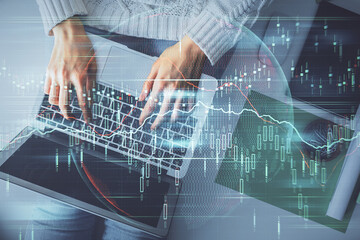 Multi exposure of woman hands working on computer and forex chart hologram drawing. Top View. Financial analysis concept.