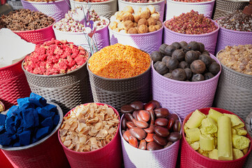 Colorful boxes with dried spices, tea and incense at bazaar market in Dubai filling the frame