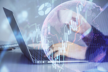 Double exposure of businesswoman hands typing on computer and forex graph hologram drawing. Financial analysis concept.