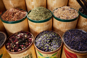 Baskets dried spices, tea and incense at bazaar market in Dubai filling the frame
