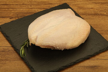 Raw whole chicken breast with skin